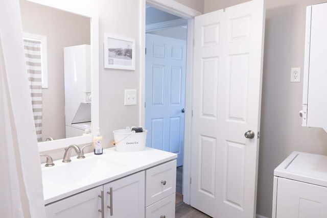 Second bathroom with the washer and dryer alongside