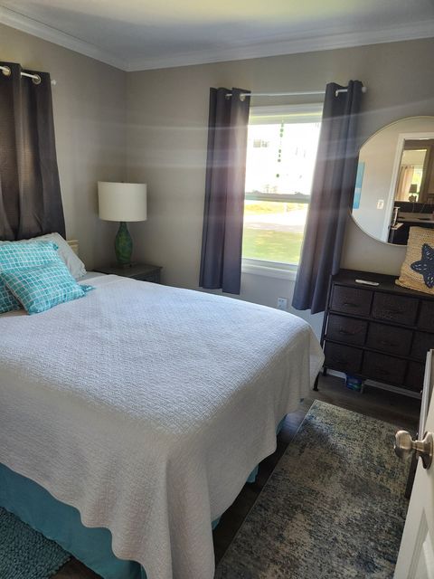 Bedroom one with a queen bed and ceiling fan