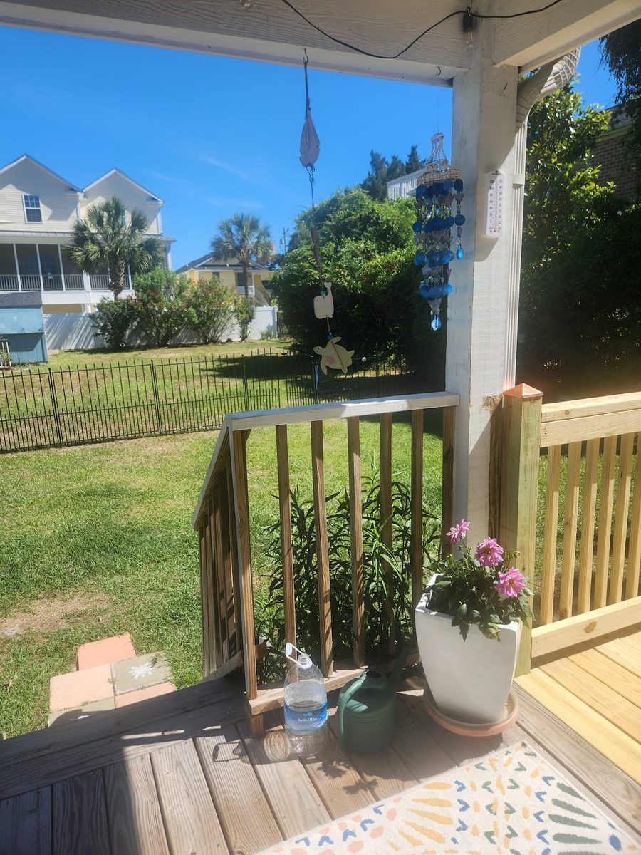 The fully fenced back yard seen from the deck