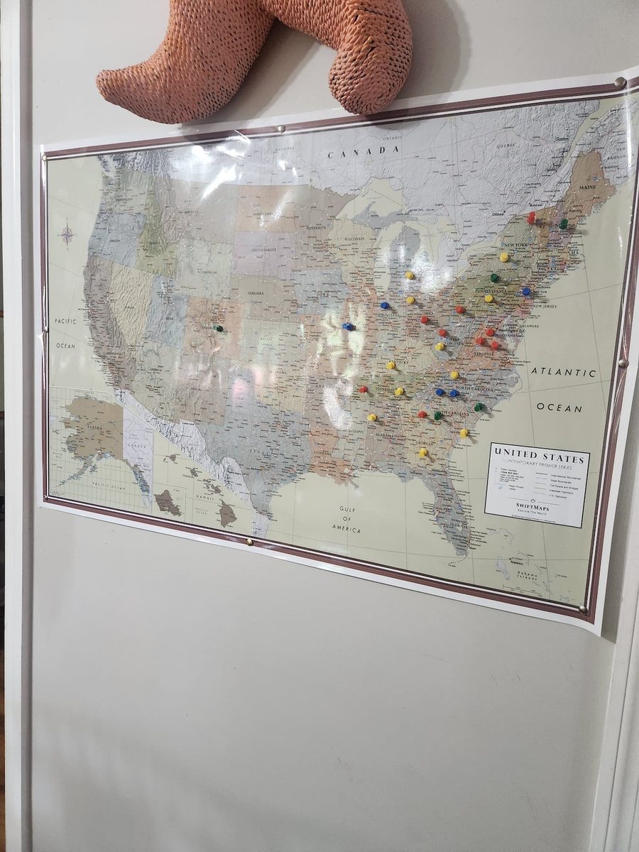The guest map on the wall, pinned by visitors from across the country