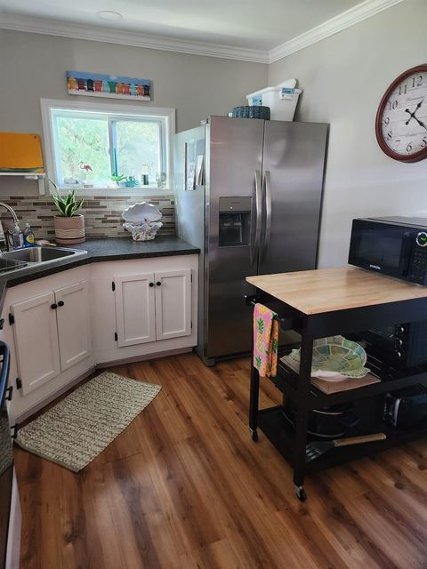 Kitchen with a stainless side-by-side refrigerator